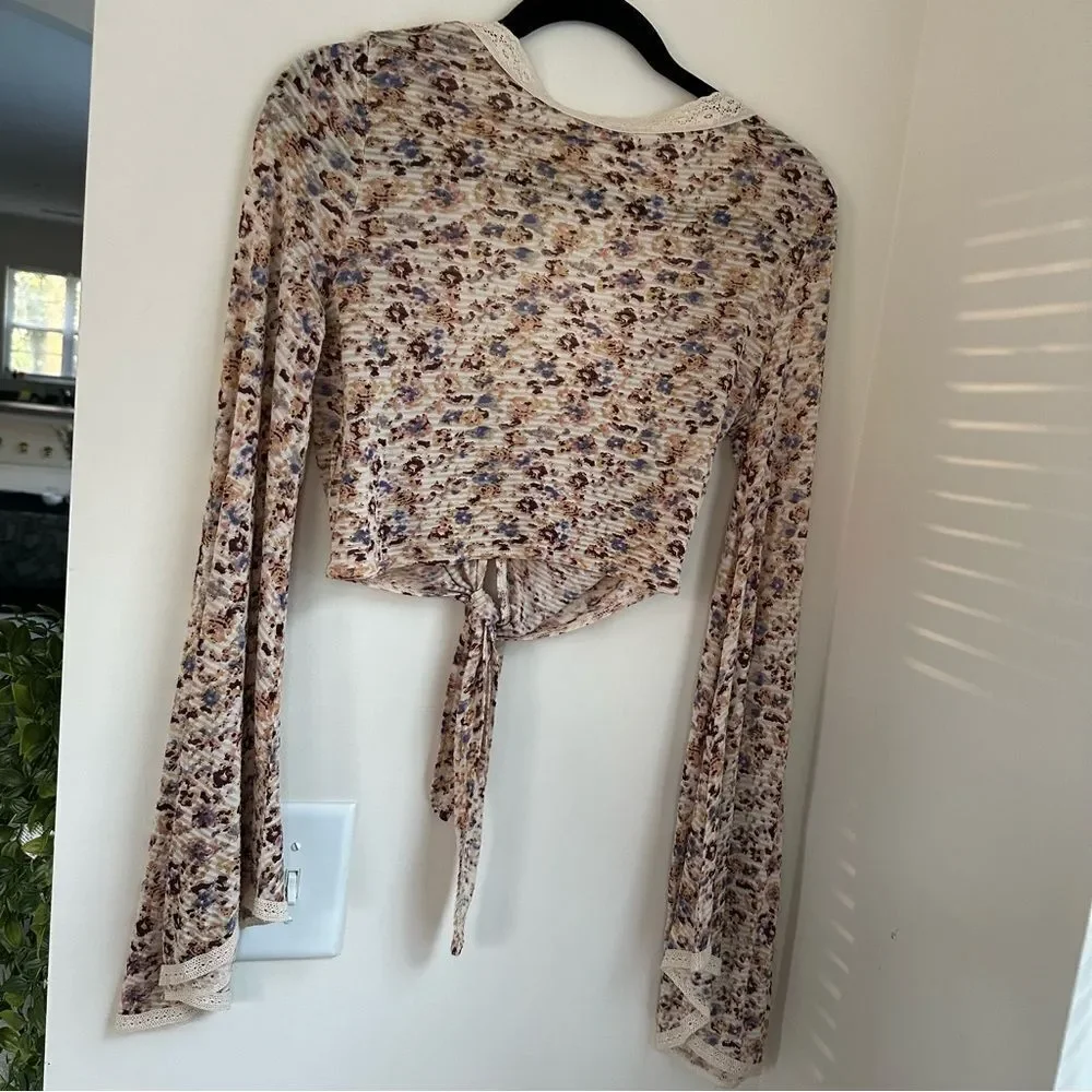 Free People cream and floral clasp front top w tie in front and bell sleeves